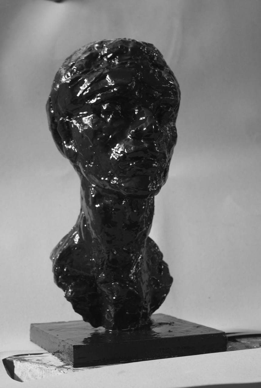Head, Blackened — full view showing the worked gloss surface