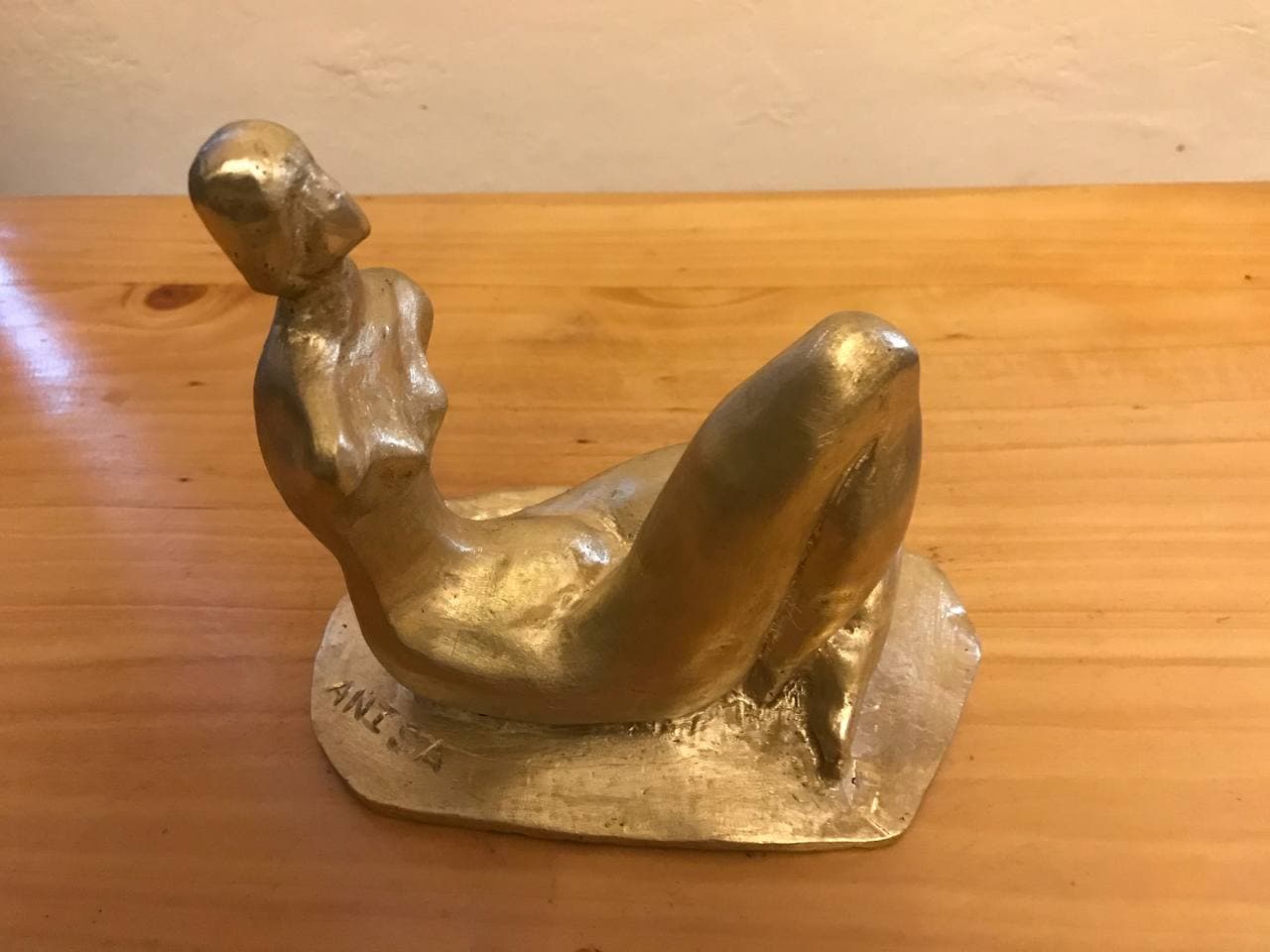 Reclining Figure, full view with the incised signature visible on the base