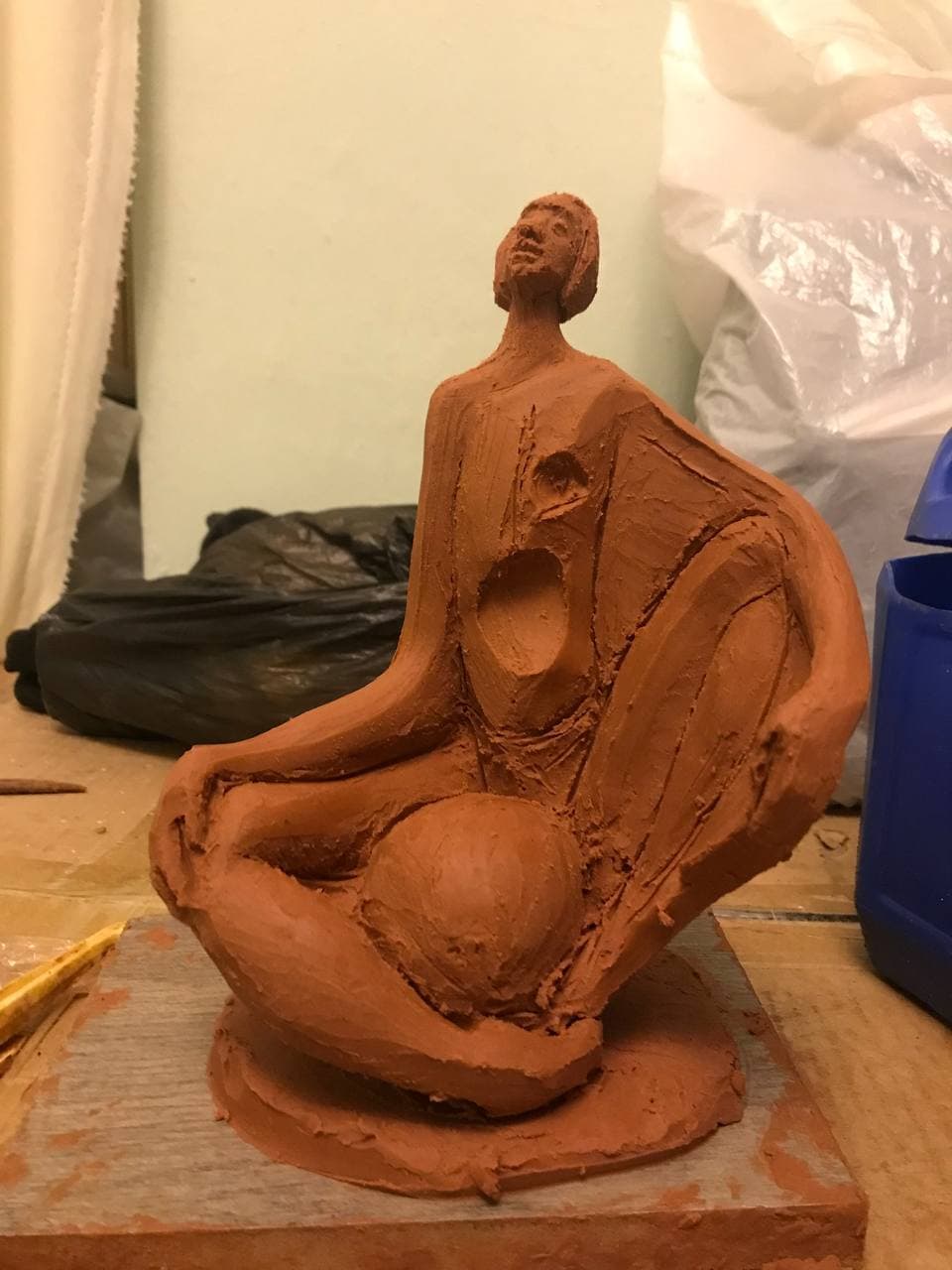 Seated Figure with Drapery, front view showing the torso voids